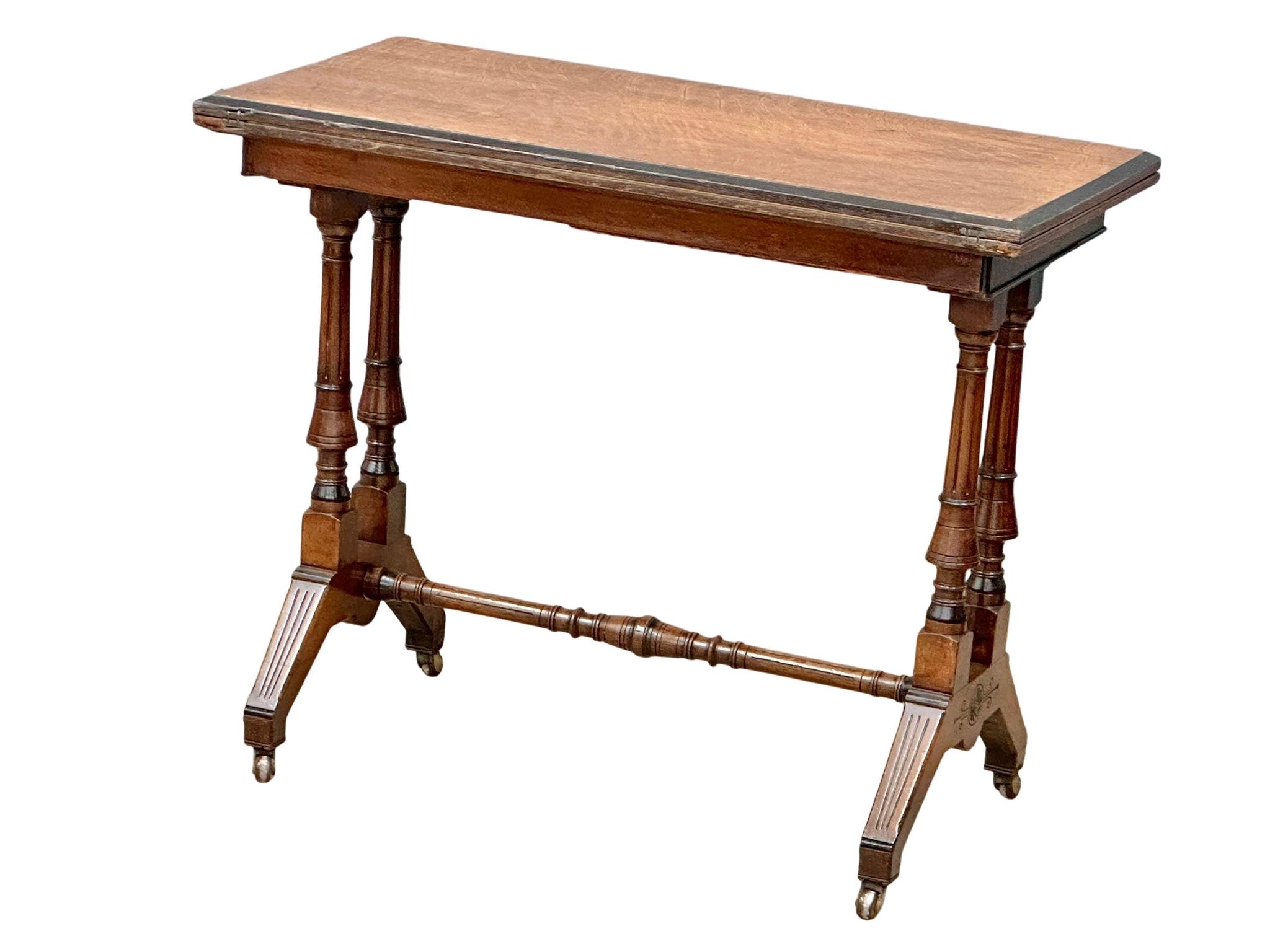 A Late Victorian oak turnover games table. 91x46x74cm