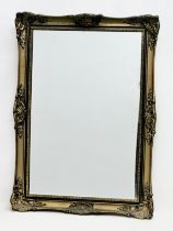 A vintage Victorian style plastic framed mirror. 57x80cm