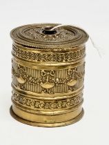 A Late 19th Century ornate brass string box. 9x10cm