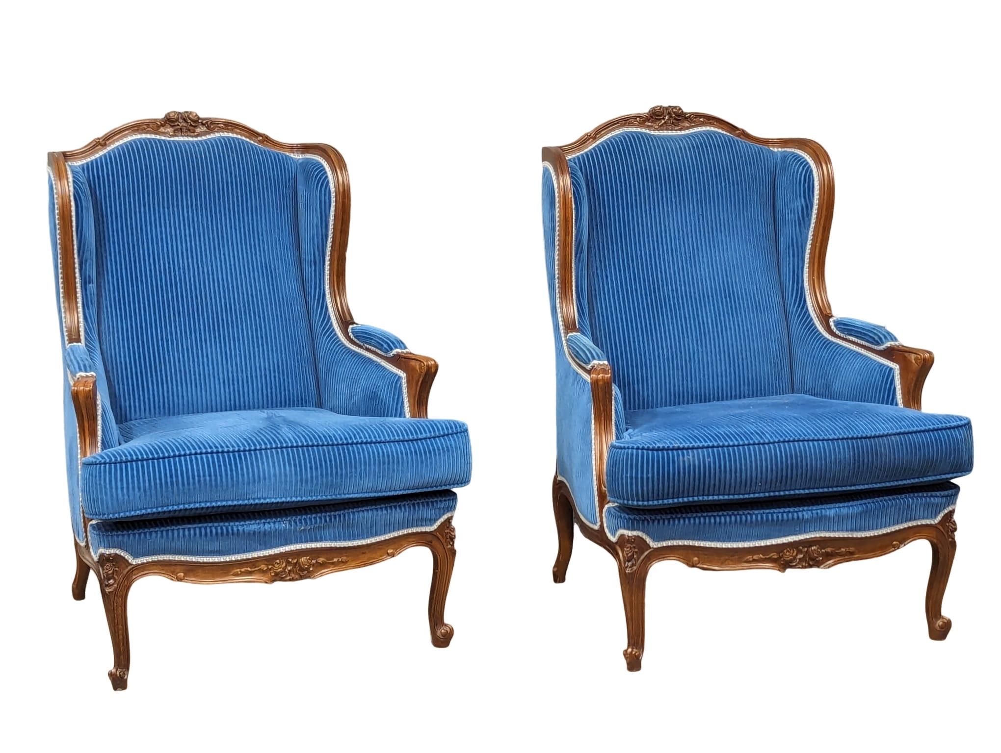 A pair of large ornate French Provincial style armchairs.