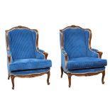 A pair of large ornate French Provincial style armchairs.