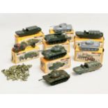 A collection of vintage Airfix HO-OO scale vehicles with boxes and soldiers.