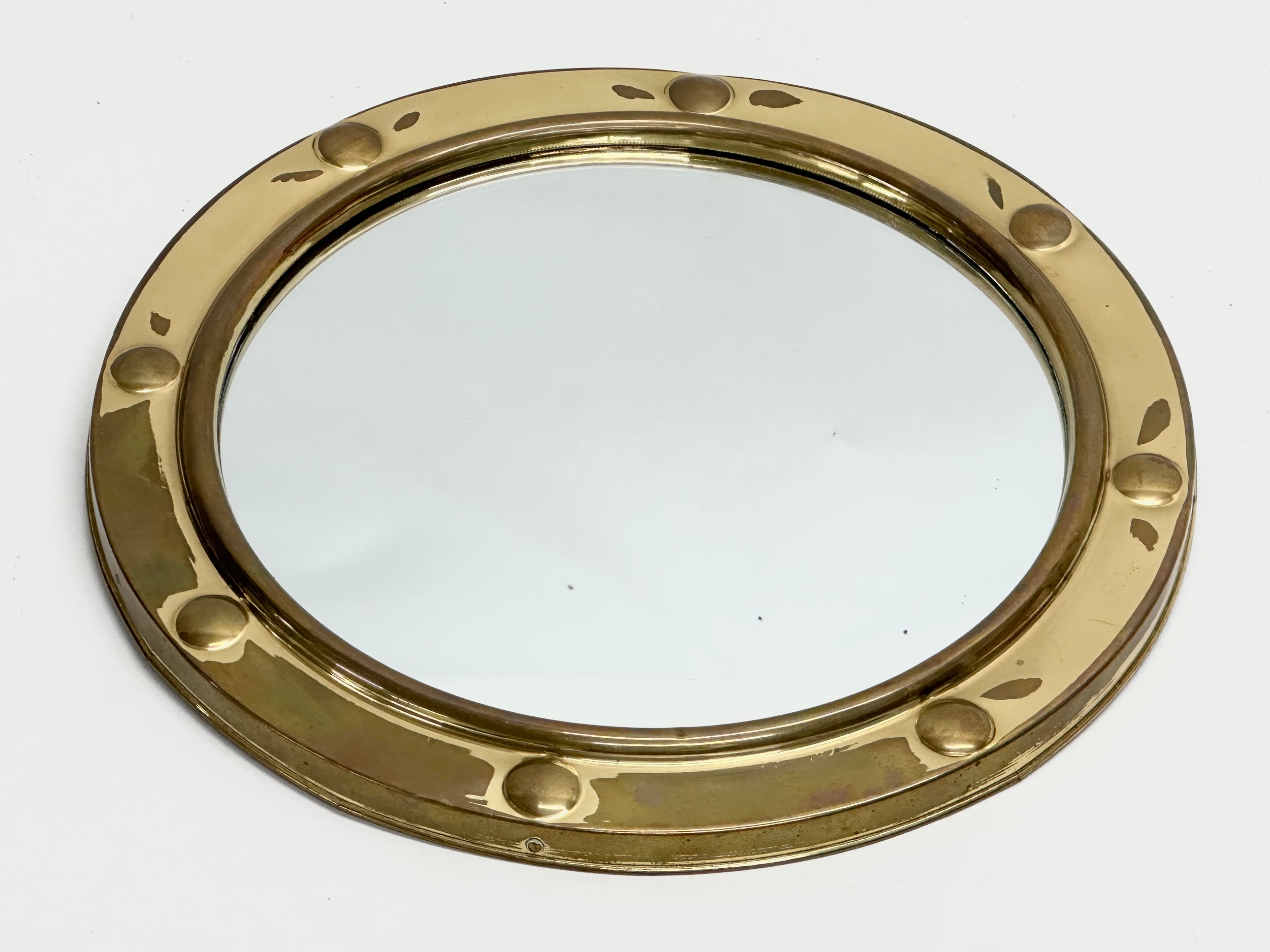 A Mid 20th Century brass framed ships porthole style convex mirror. 30cm