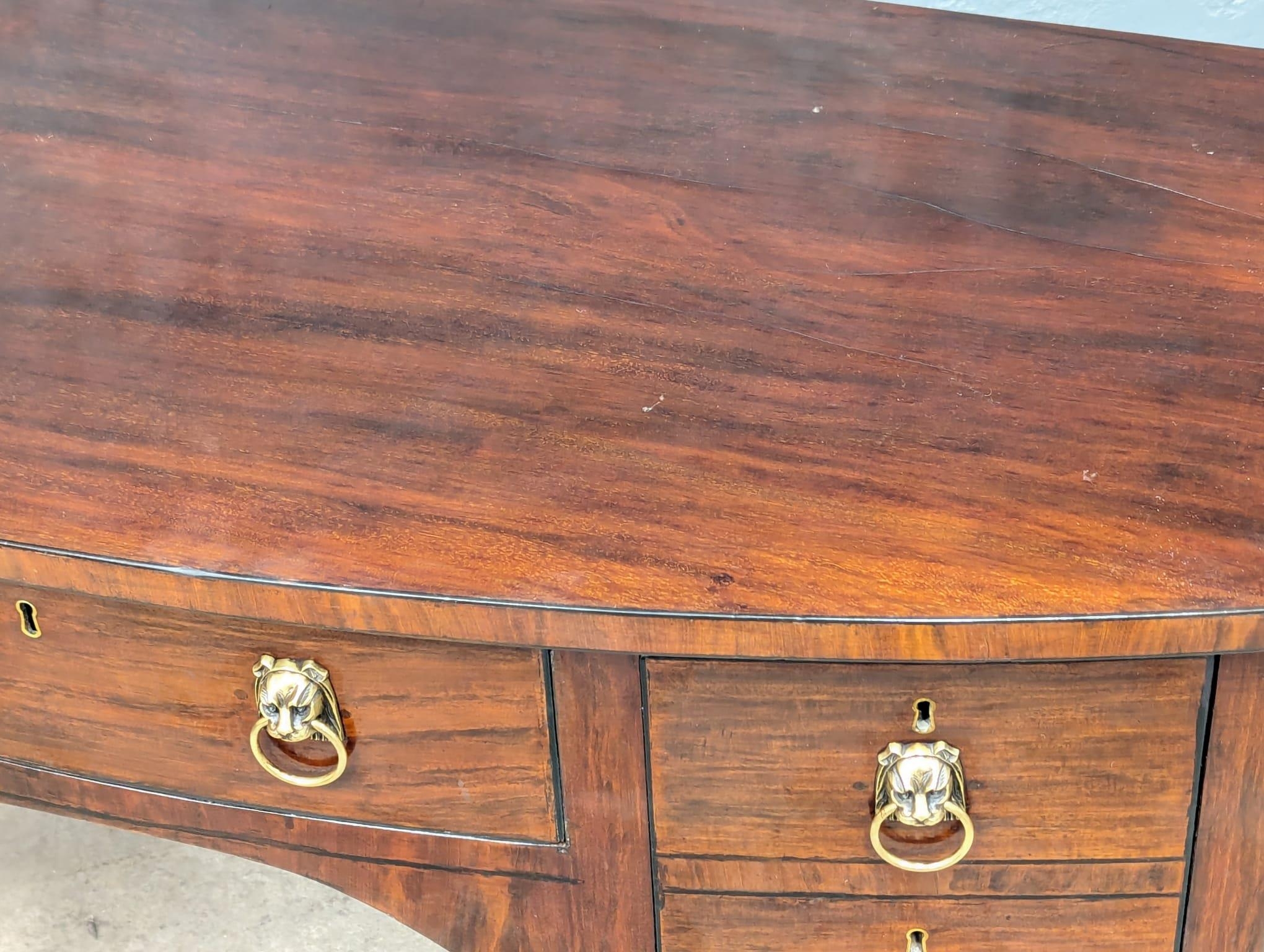 A 19th Century mahogany bow front side table with brass lion mask handles. By Spillman & Co. London. - Image 6 of 7