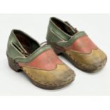 A pair of vintage child’s Folk Art leather and wooden clogs.