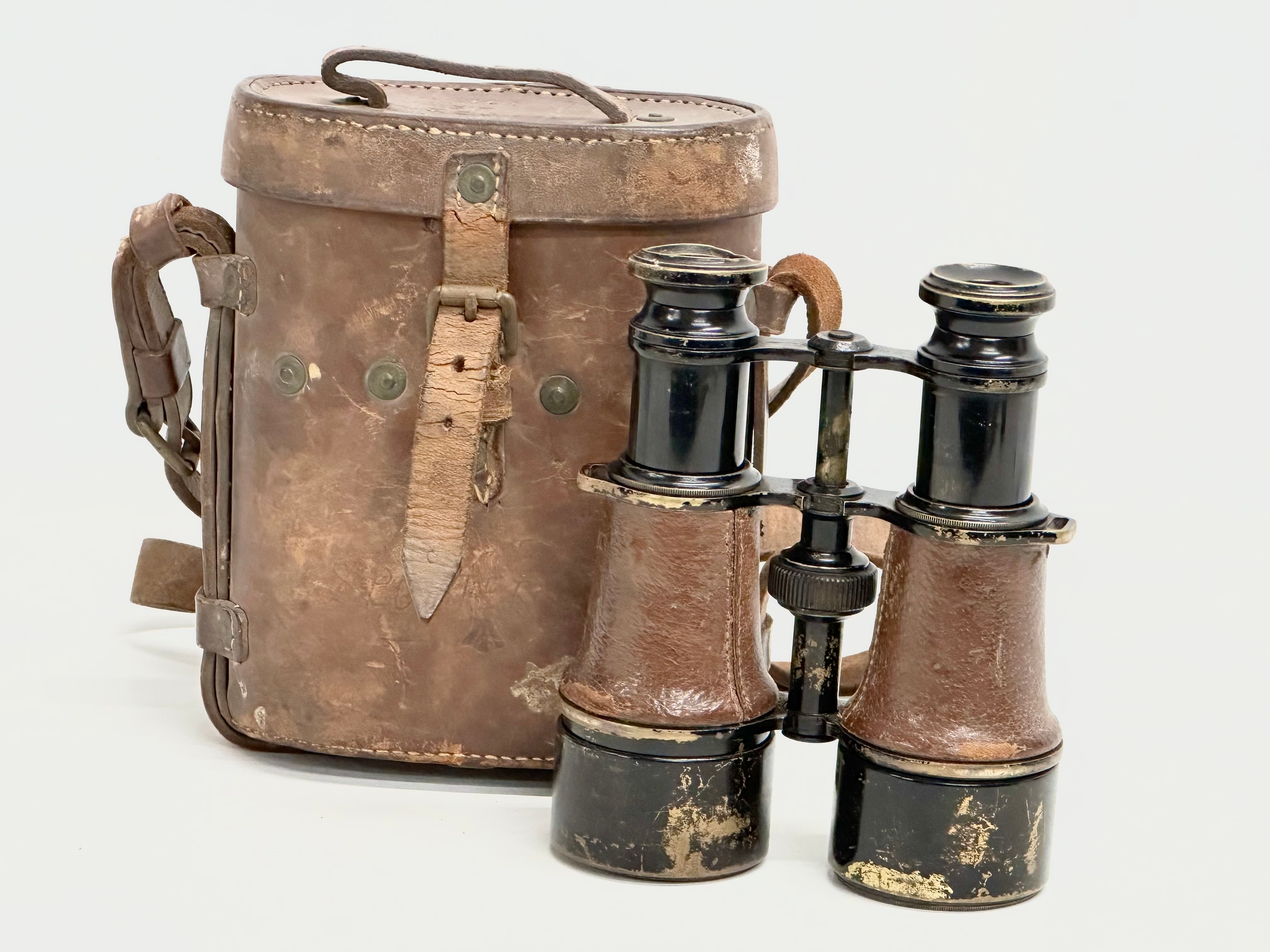 A pair of WWI field binoculars with original leather case. G. Battle.