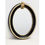 A gilt framed oval mirror. 41x52cm