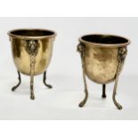 A pair of Mid/Late 19th Century brass jardinières/planters raised on 3 lion paw feet and copper