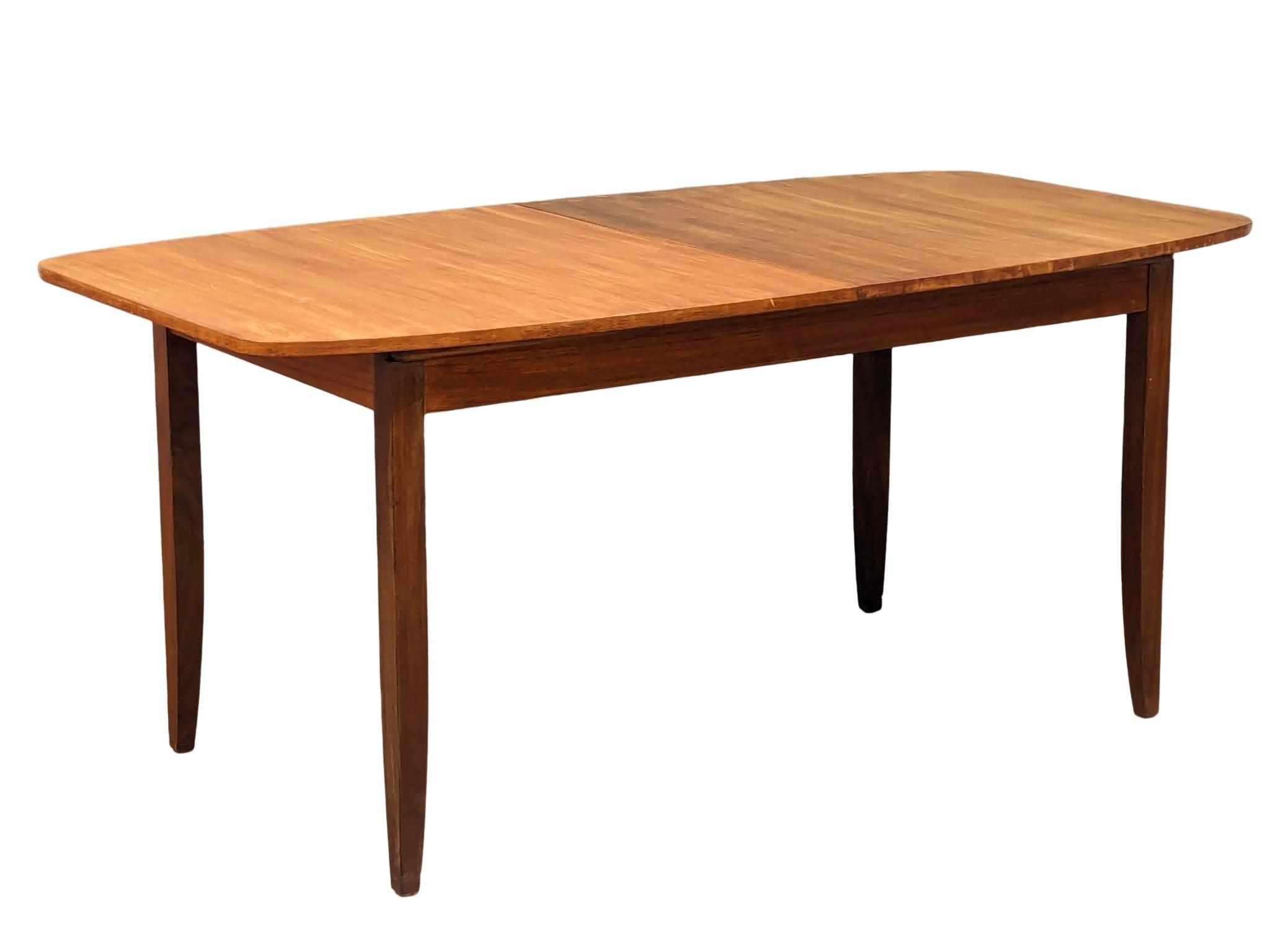 A mid century teak table and 6 chairs, 168cm x 89cm x 75cm. Extended 211cm x 89cm x 75cm - Image 12 of 17