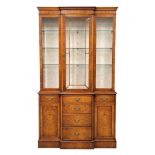 A George III style burr elm Serpentine front display cabinet. With adjustable glass shelves.