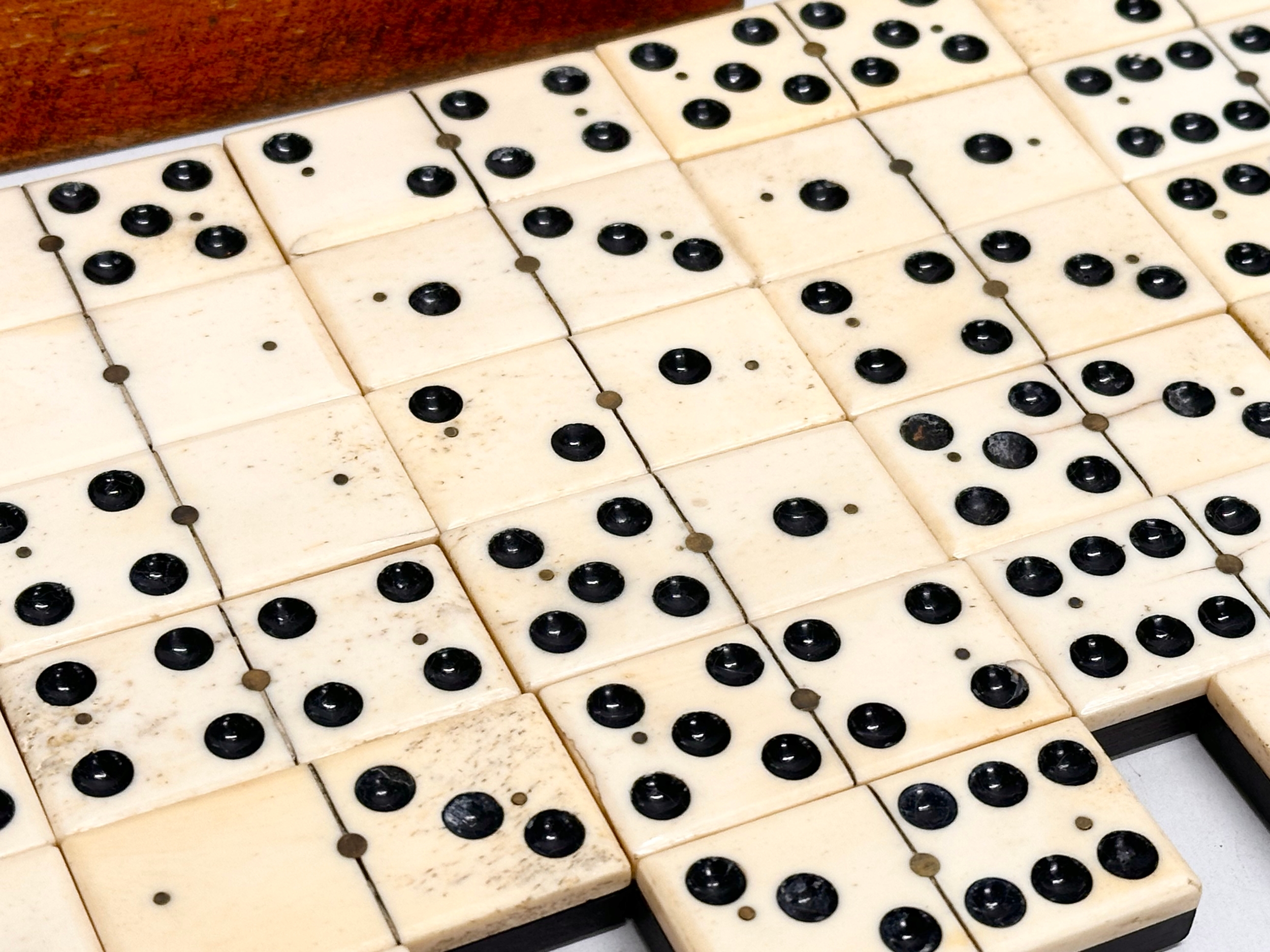 A collection of 19th Century bone and ebony dominoes with wooden box. Pieces 5.5cm. Box 21cm. - Image 4 of 6