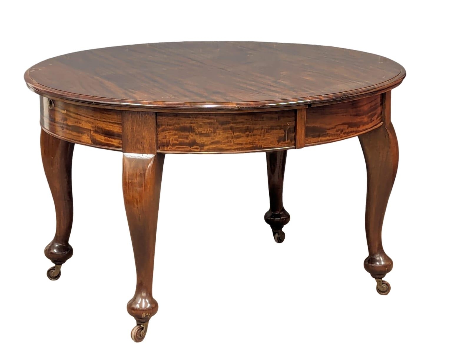 An early 20th Century mahogany telescopic dining table with 2 leaves, 185cm x 113cm x 76cm extended.