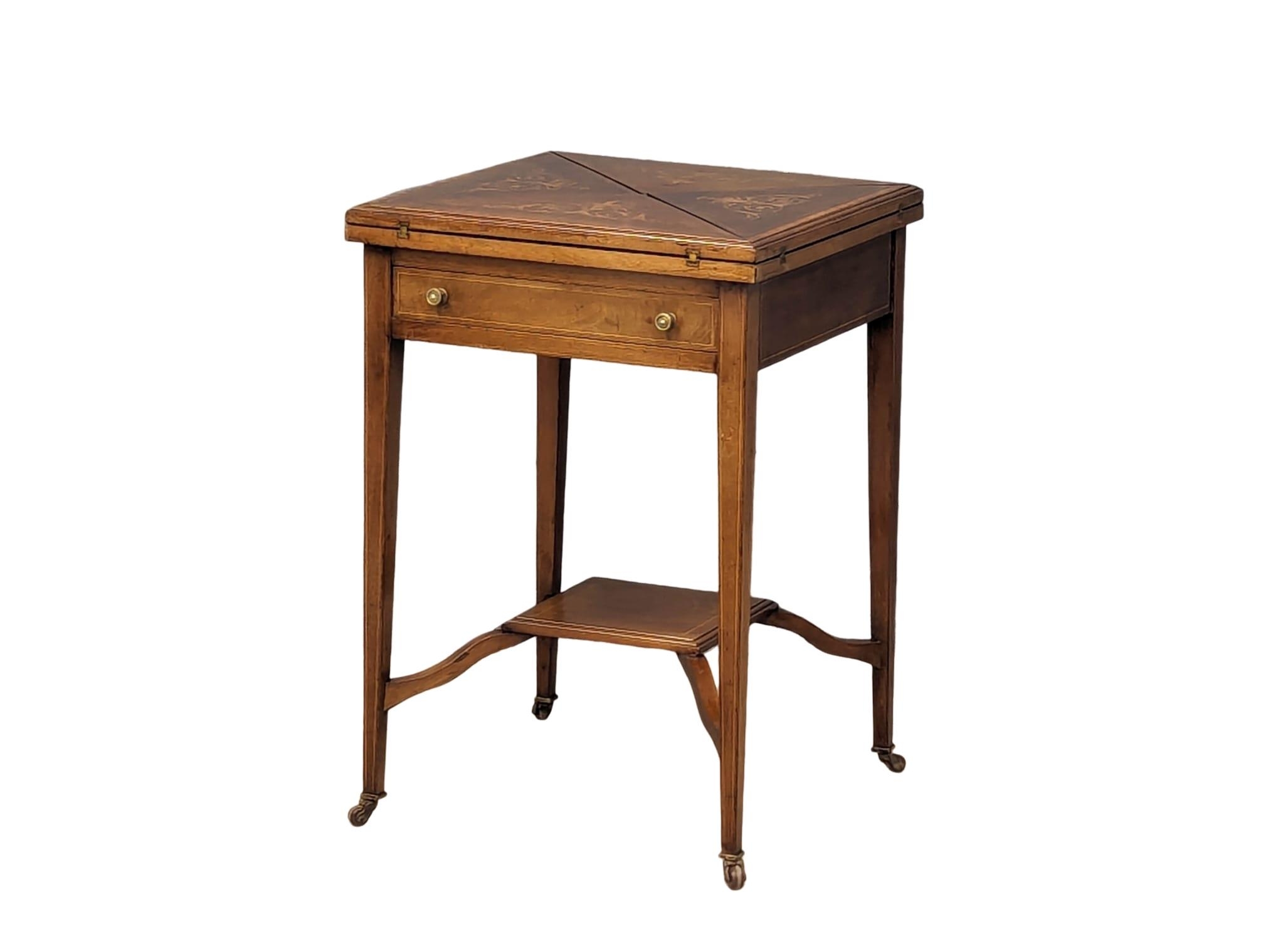 An Edwardian inlaid mahogany envelope turnover games table. 53.5x77.5cm