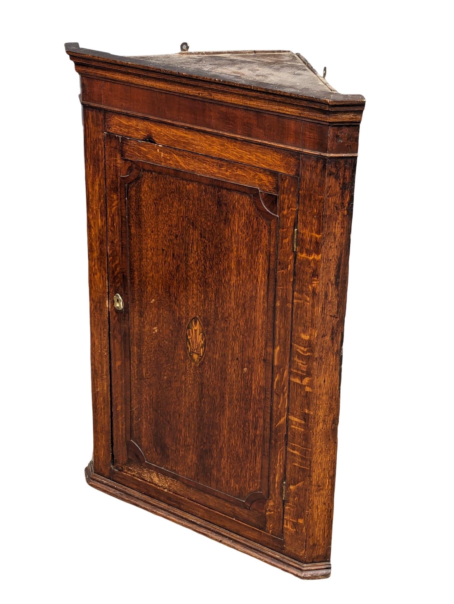 A George III inlaid oak wall hanging corner cabinet with fitted shelves. Circa 1790-1800. 69.5x38. - Image 2 of 5