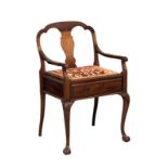 An Early 20th Century mahogany piano chair / armchair on ball and claw feet. Circa 1900-1910.