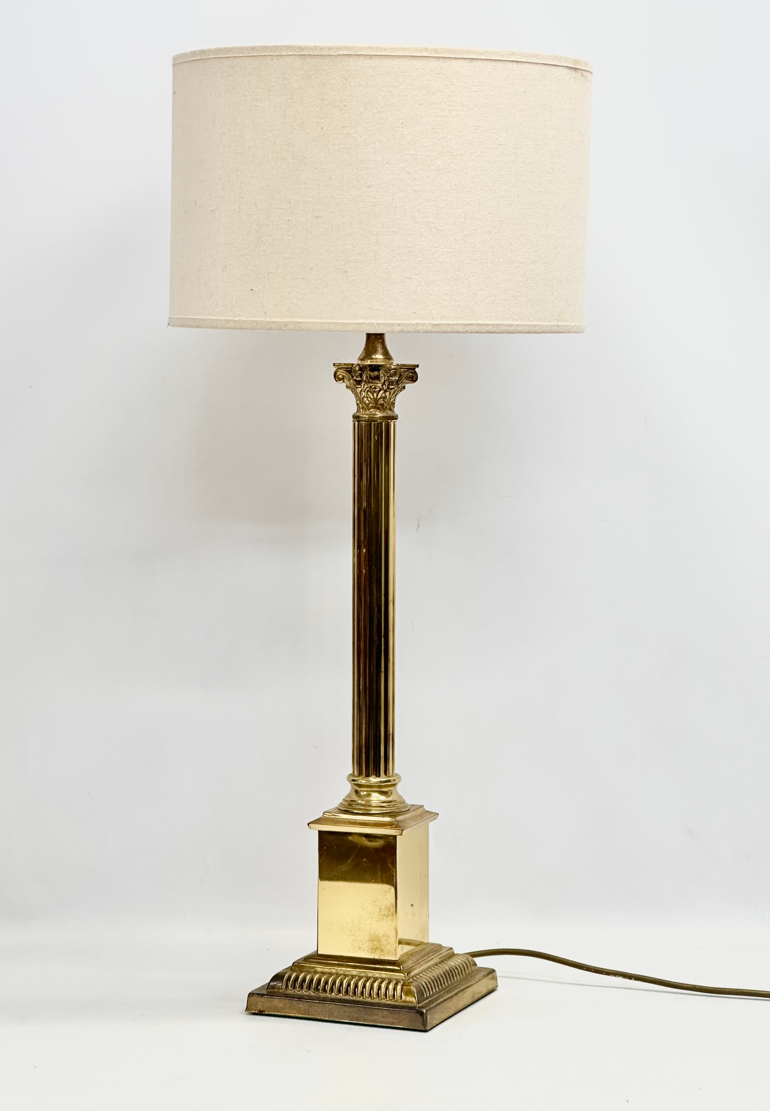 A large 20th Century brass table lamp with Corinthian column. Base measures 17x17x64cm