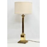 A large 20th Century brass table lamp with Corinthian column. Base measures 17x17x64cm