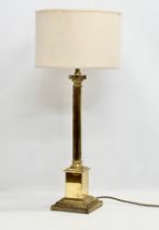 A large 20th Century brass table lamp with Corinthian column. Base measures 17x17x64cm