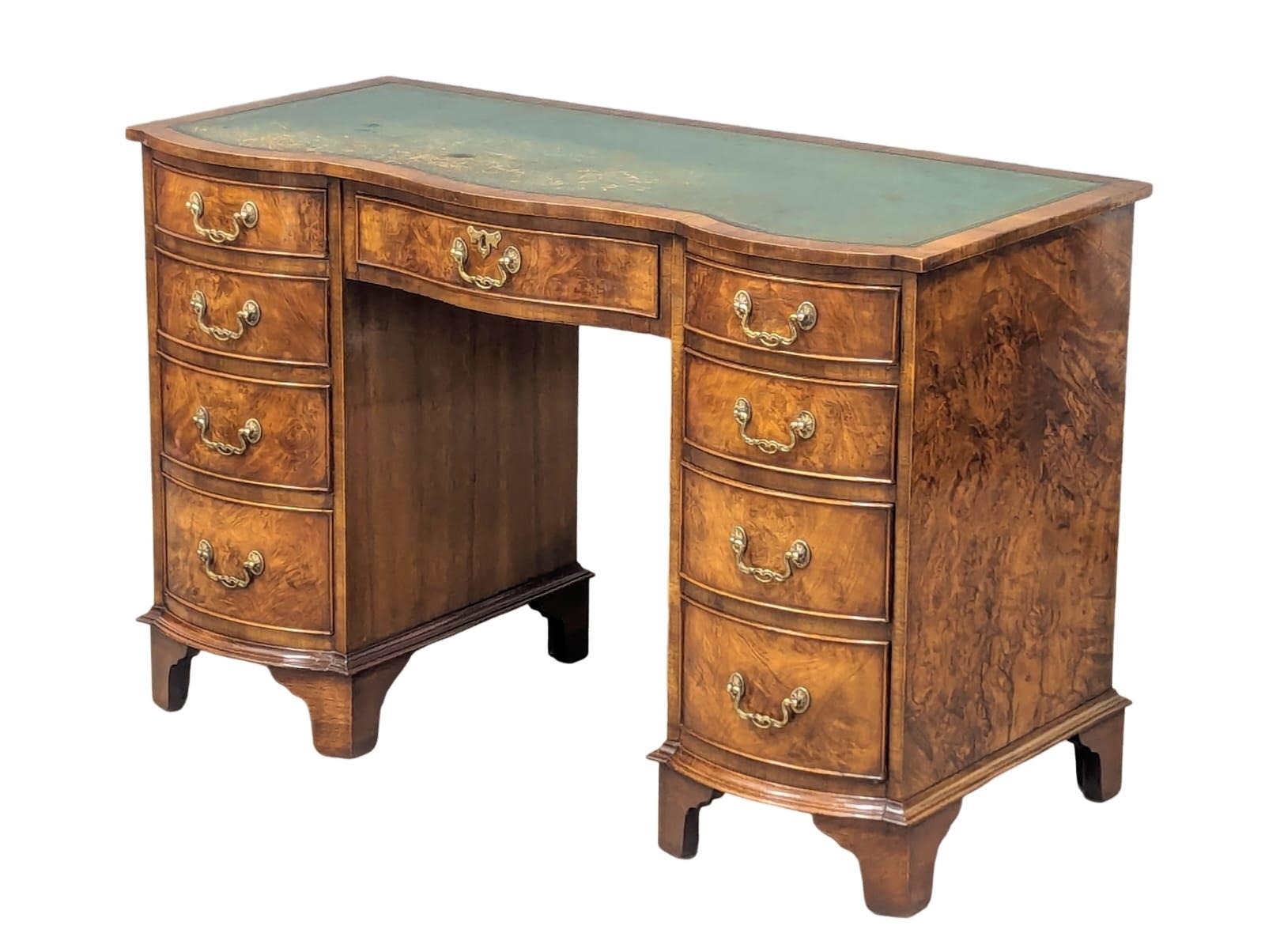 A Georgian style mahogany and burr walnut pedestal desk with leather top. 115x53.5x75cm