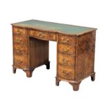 A Georgian style mahogany and burr walnut pedestal desk with leather top. 115x53.5x75cm