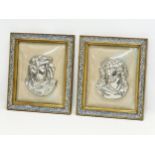 A pair of Early 20th Century plated religious wall plaques with convex glass and gilt frames.