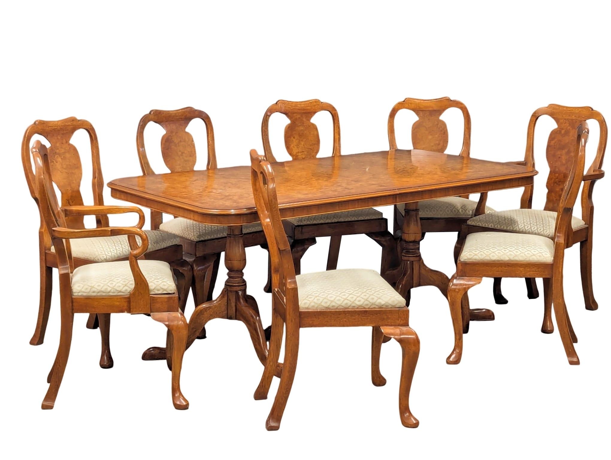 A Georgian style walnut extending dining table with 8 chairs. Table measures 176x100x75cm