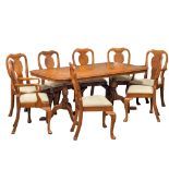 A Georgian style walnut extending dining table with 8 chairs. Table measures 176x100x75cm