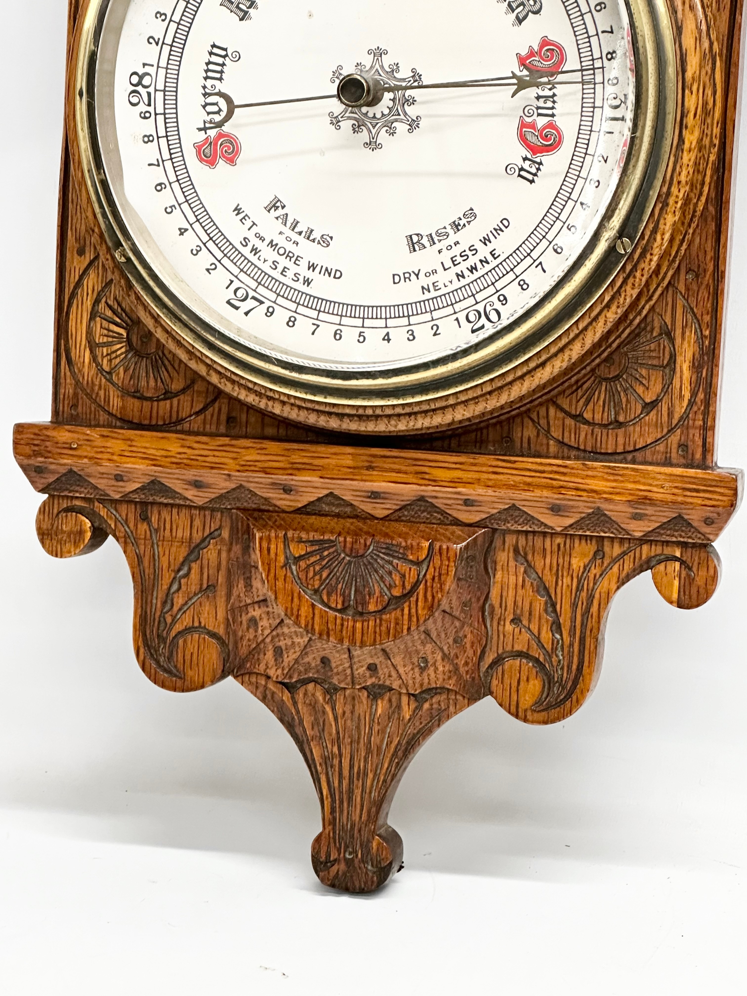 A Victorian carved oak barometer. 28x84cm W - Image 2 of 5