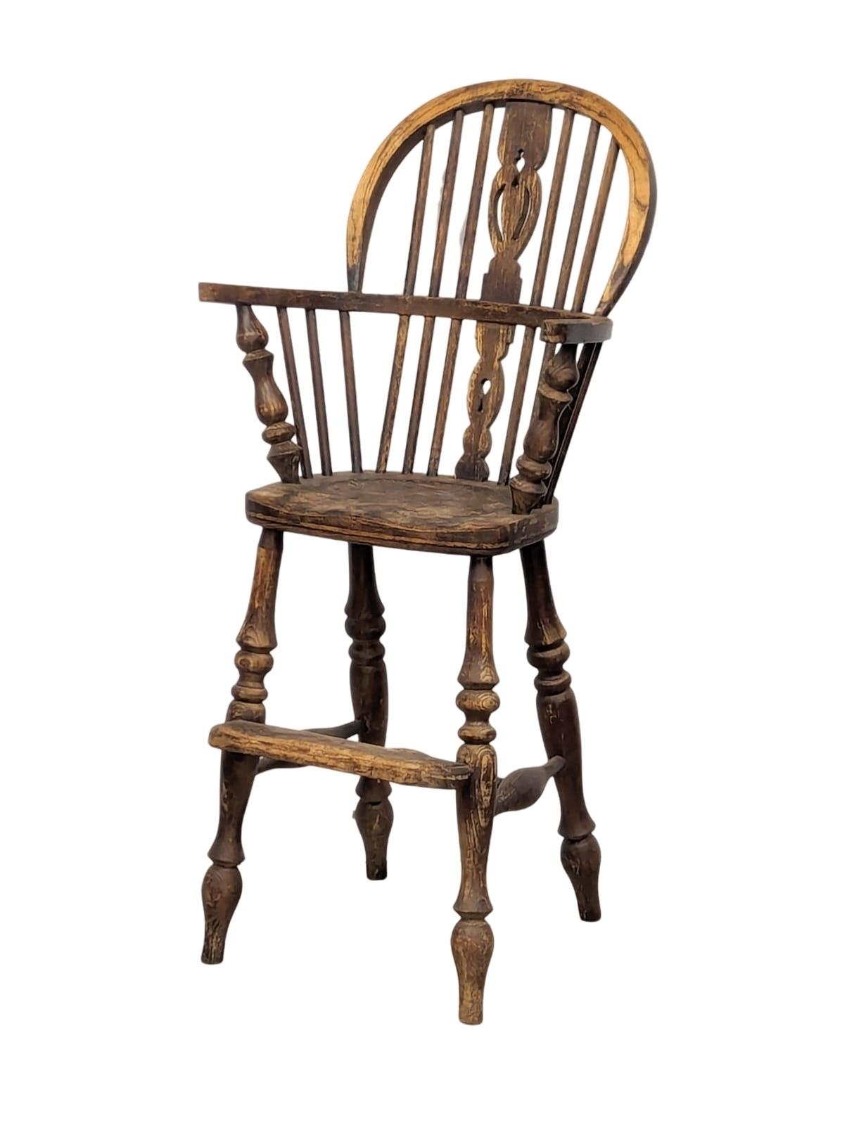 A Late 19th Century elm and beech Windsor style child's highchair.