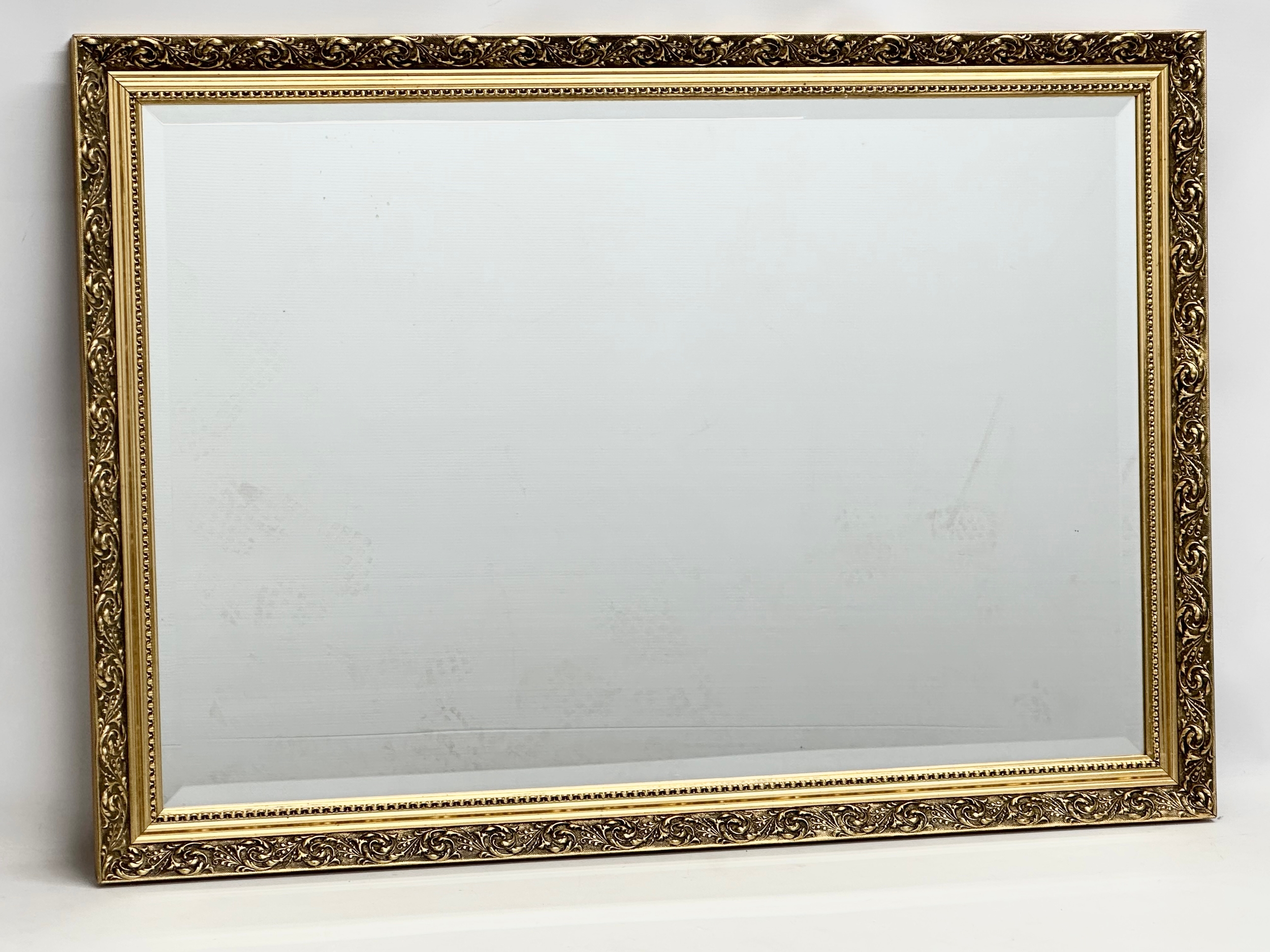 A large gilt framed mirror. 99x70cm