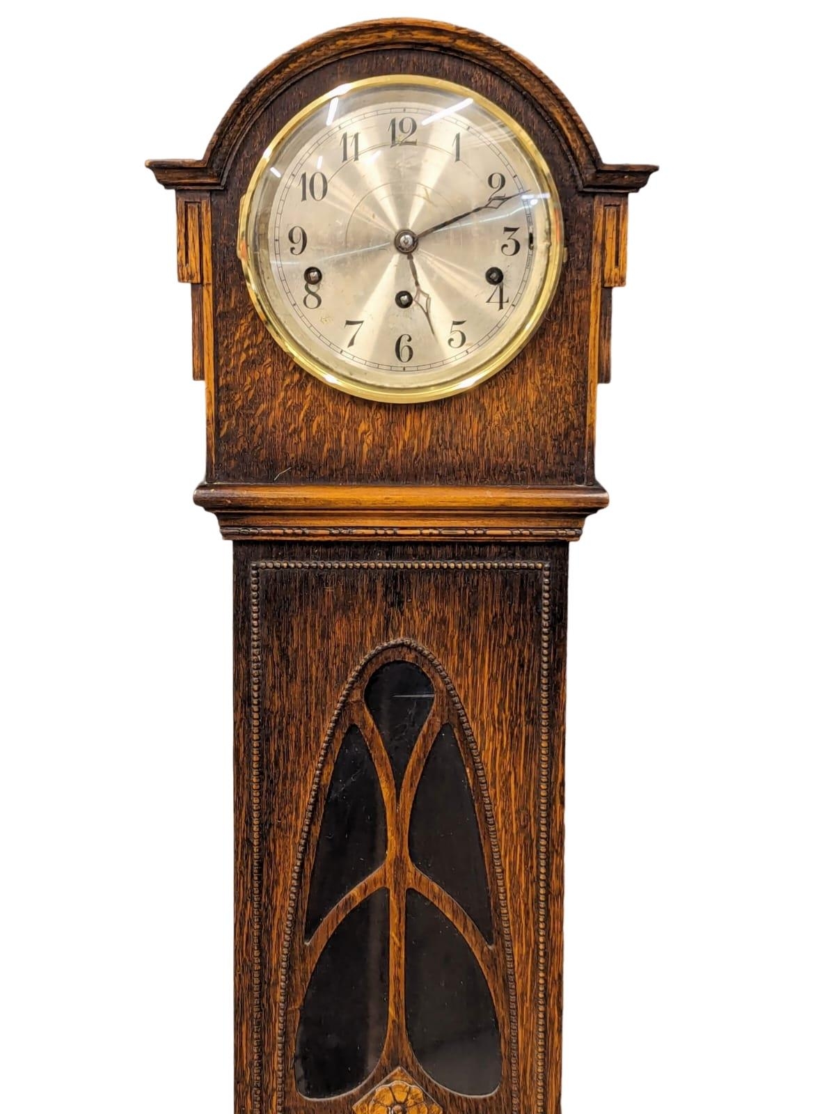 A 1930s oak cased granddaughter clock with West Minister chimes. With pendulum and key. 142cm - Image 2 of 3