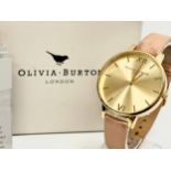 An Olivia Burton watch with box.