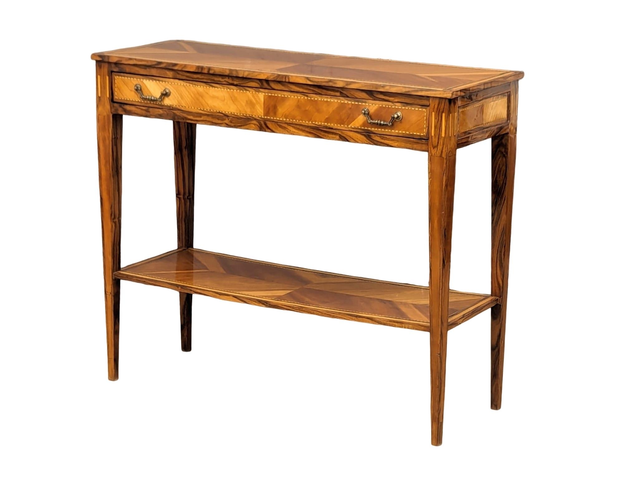 A good quality 2 tiered console table. Made from various woods, including Laburnum, Arbutus,