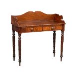 A late George IV mahogany gallery back side table on reeded legs, containing 2 front facing drawers.