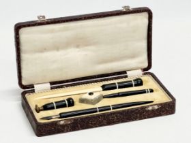 An Early 20th Century C. Brandauer pen set in case. Inkwell, seal, fountain pen, letter opener etc.