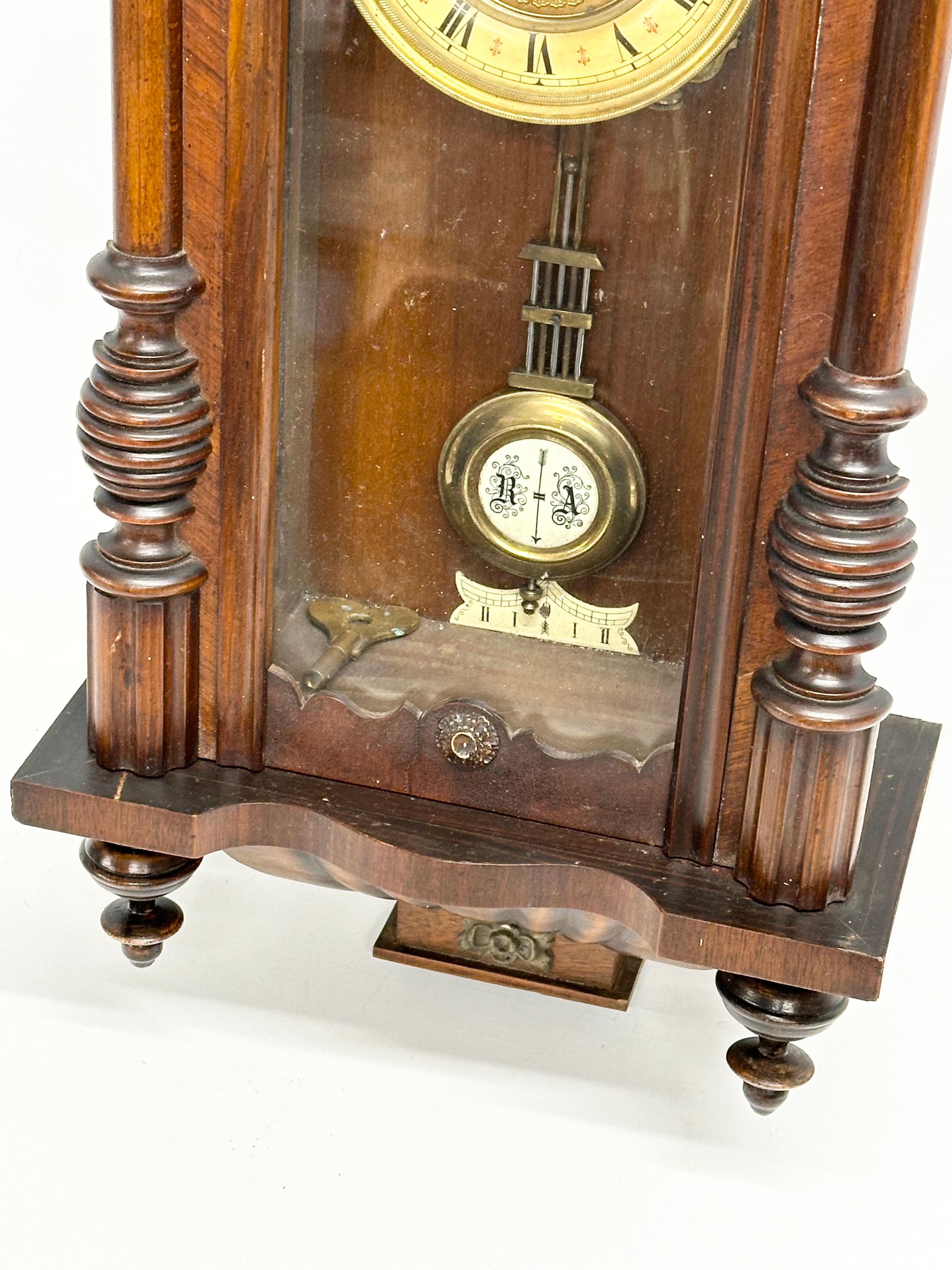 A Late 19th Century Victorian spring Vienna wall clock. With key and pendulum. 34x82cm - Image 4 of 4