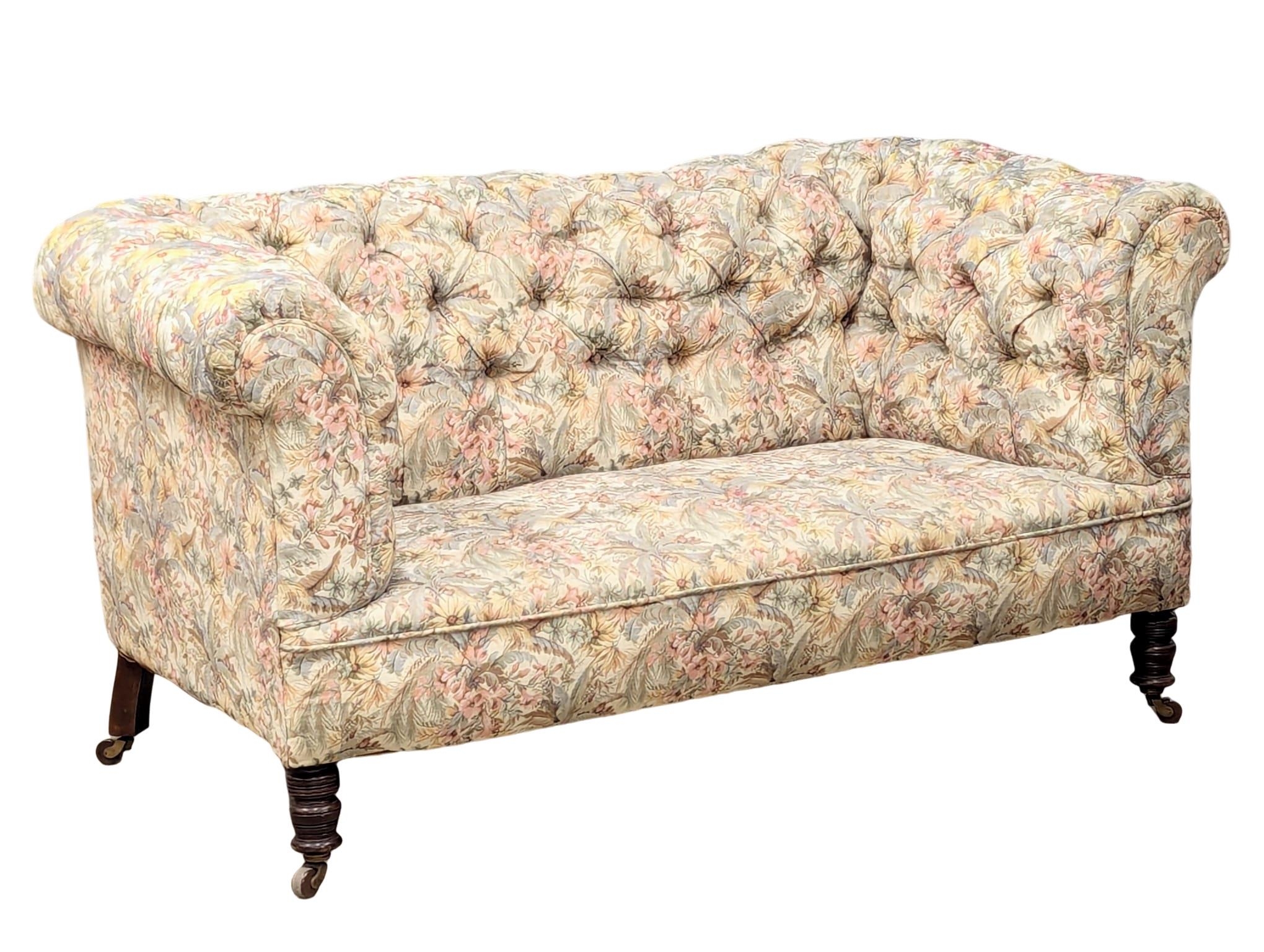 A Late 19th Century Victorian deep button back 2 seater sofa on turned legs. Circa 1880. 164.5cm