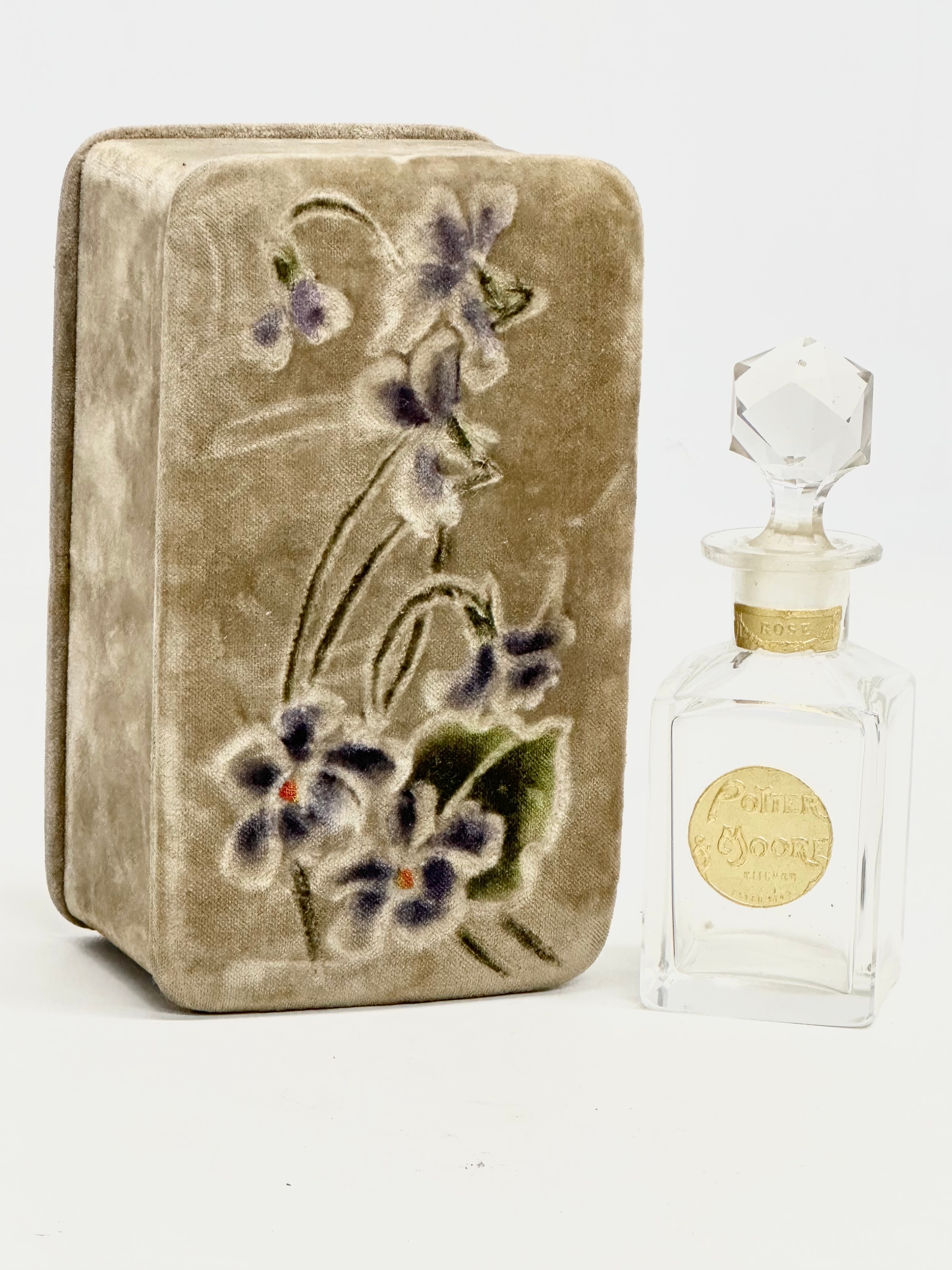 An Early 20th Century Pottery Moore perfume bottle with original case.