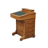 A Victorian walnut Davenport desk with maple interior.