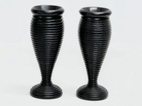 A pair of Late 19th Century turned ebony candleholders/vases. 16cm.