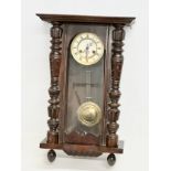 A Late 19th Century Victorian mahogany Vienna wall clock. With key and pendulum. 42x64cm