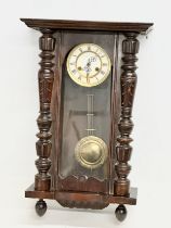 A Late 19th Century Victorian mahogany Vienna wall clock. With key and pendulum. 42x64cm