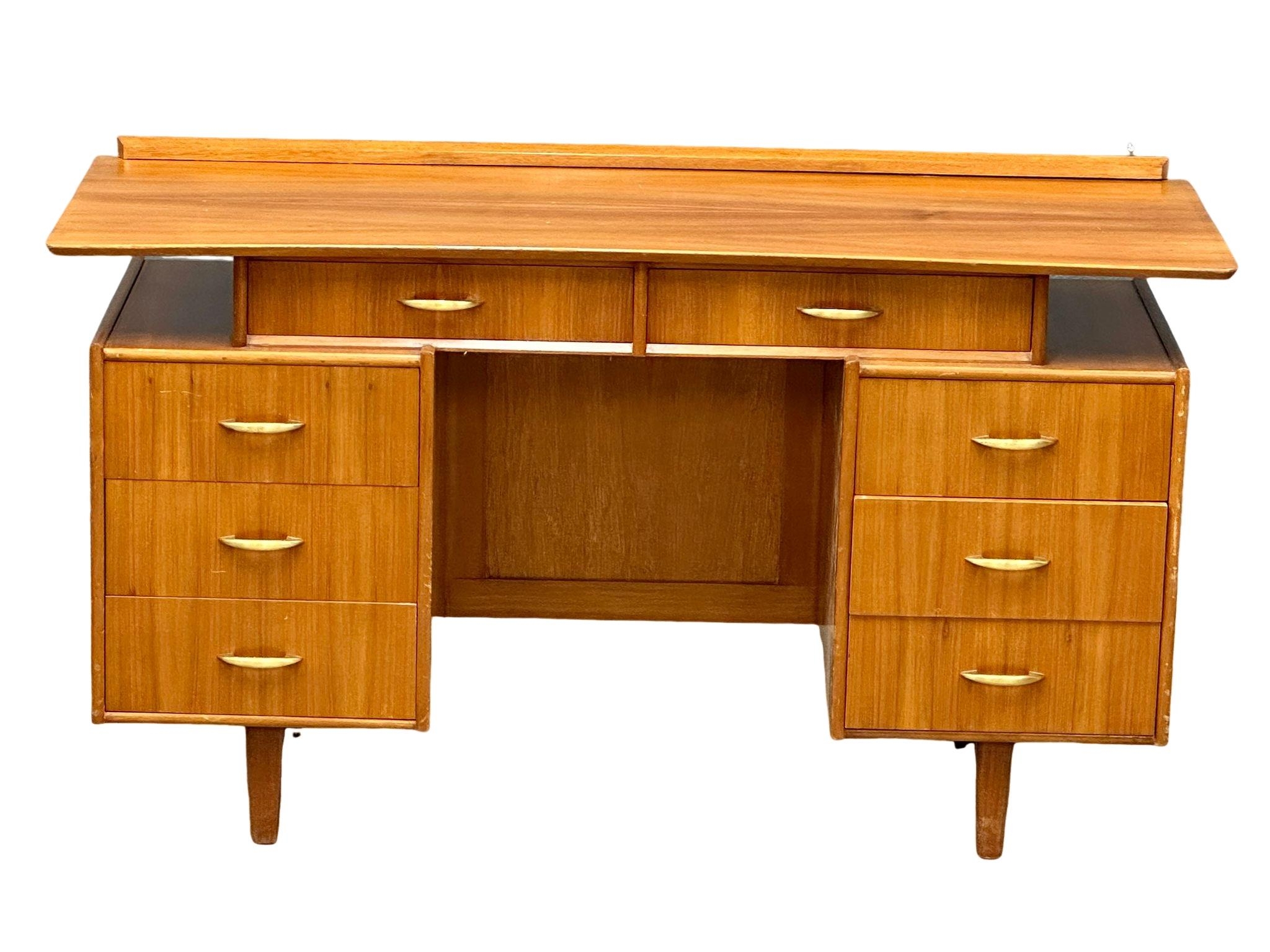 A Mid Century walnut desk/dressing table, 131cm x 49cm x 74.5cm