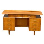 A Mid Century walnut desk/dressing table, 131cm x 49cm x 74.5cm