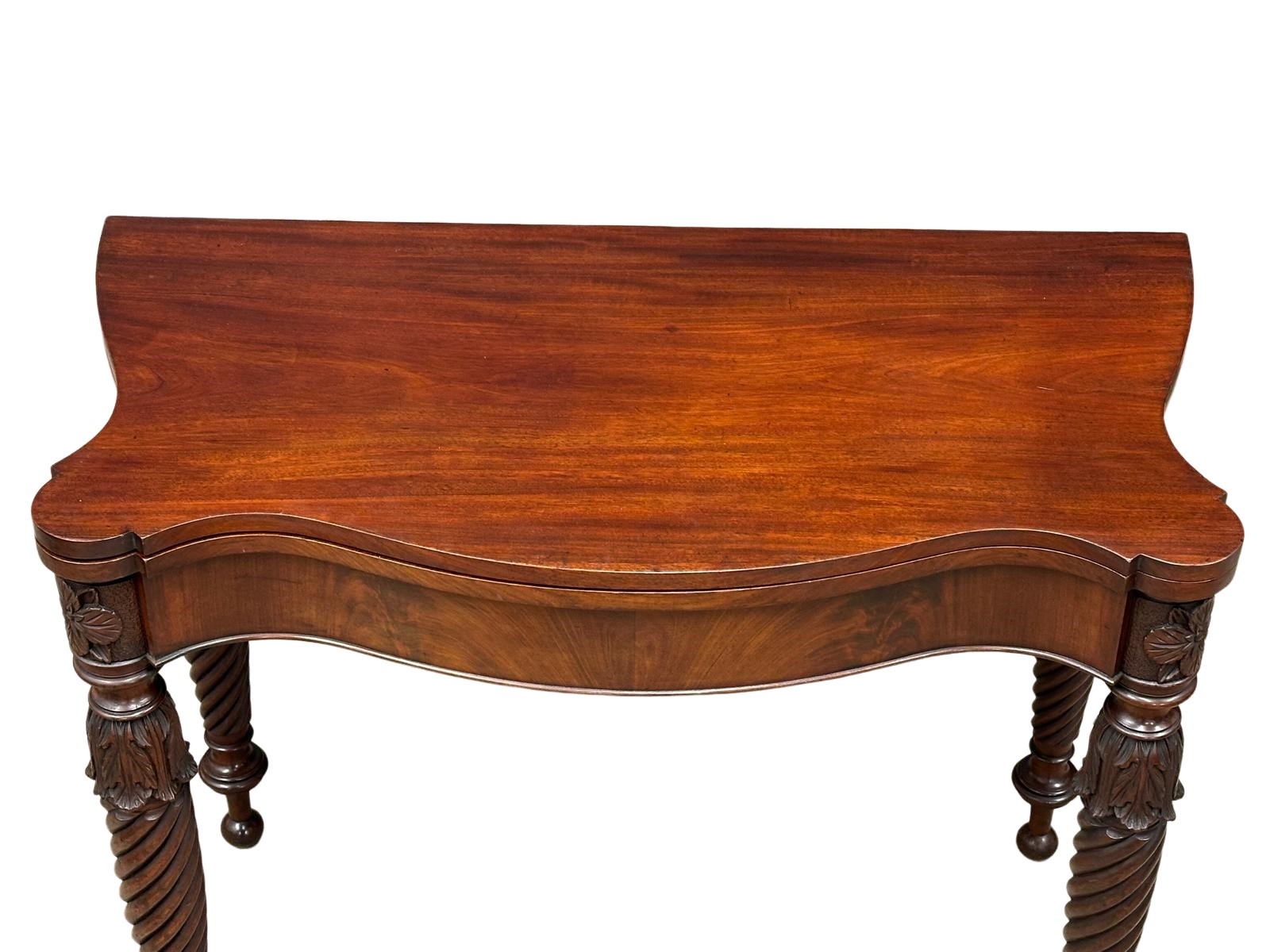 A William IV mahogany serpentine front turnover tea table on turned legs. Circa 1830. 87x44x75cm - Image 8 of 9