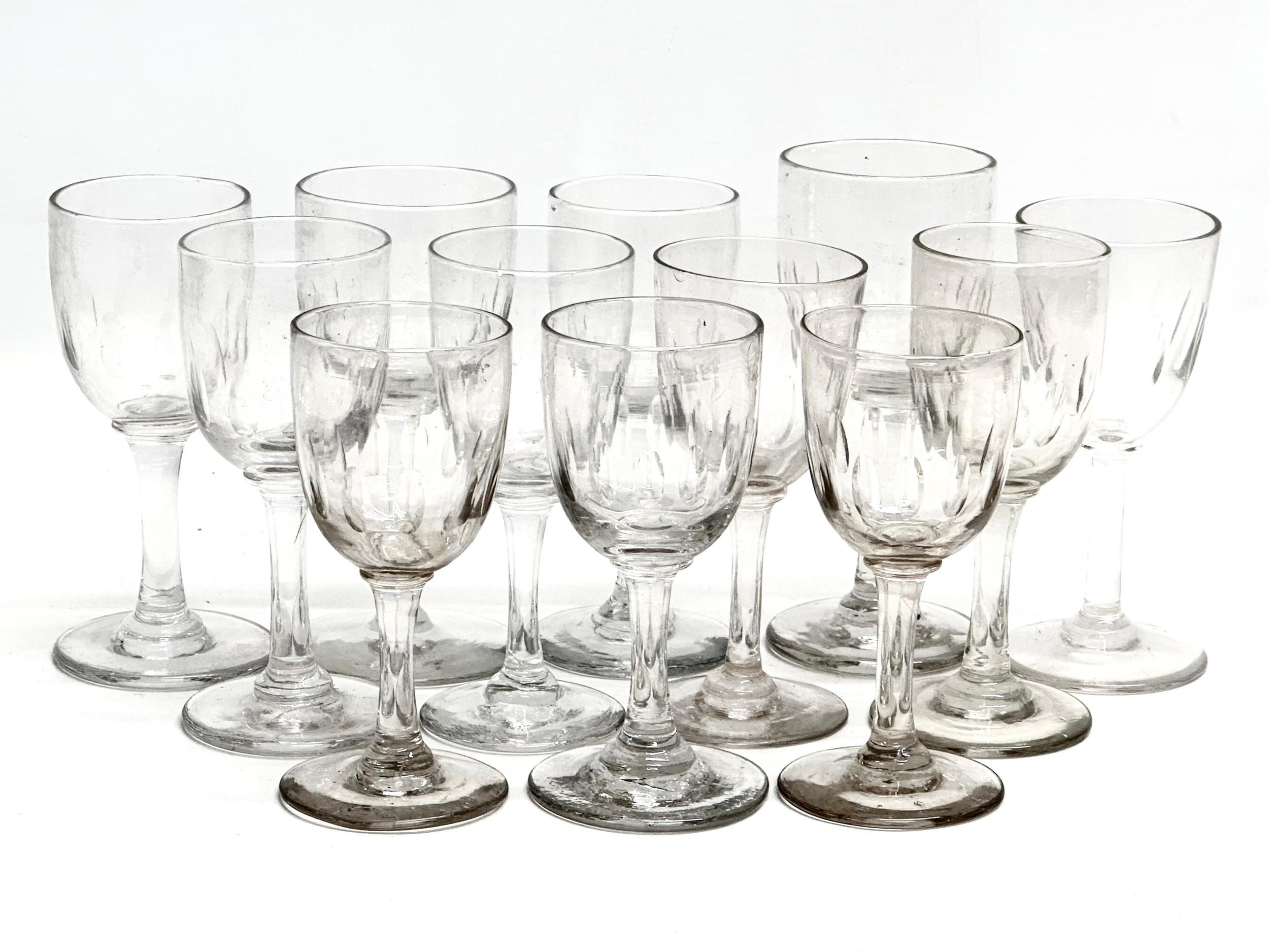 A set of 12 Mid 19th Century Victorian slice cut port glasses. 12cm. 11.5cm. 11cm.