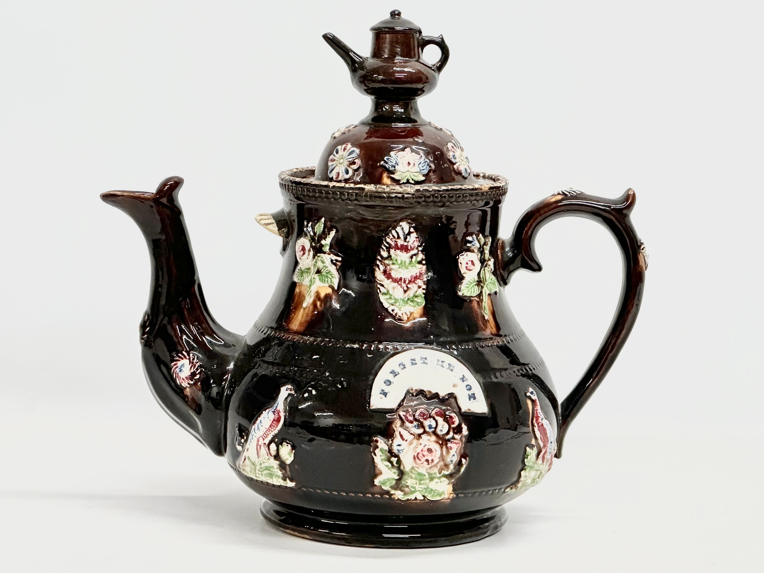 A large Late 19th Century Measham Pottery ‘Bargeware’ teapot. Circa 1880-1890. Forget Me Not.