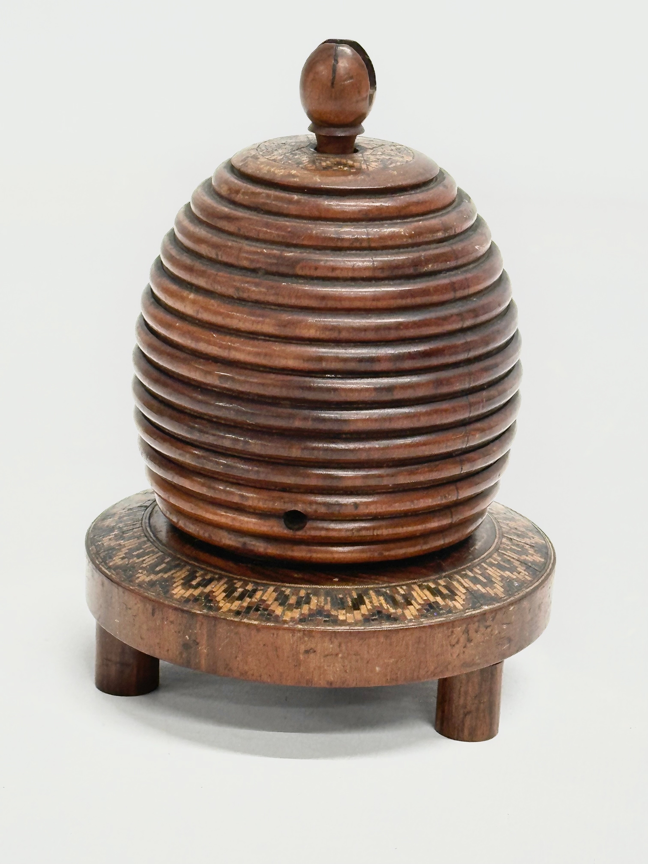 A Mid 19th Century Lignum Vitae turned fruitwood beehive string box. 9x12cm