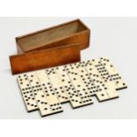 A collection of 19th Century bone and ebony dominoes with wooden box. Pieces 5.5cm. Box 21cm.