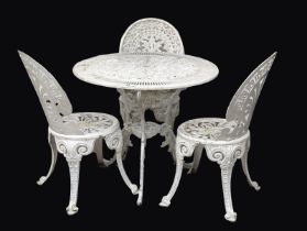An ornate Victorian style cast alloy garden table and 3 chairs